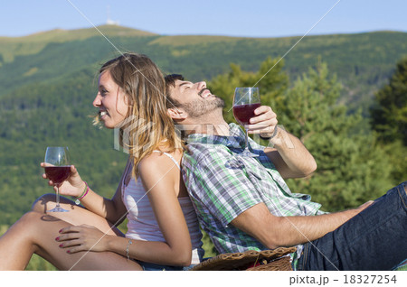 Happy couple drinking wine on a hiking trip 18327254
