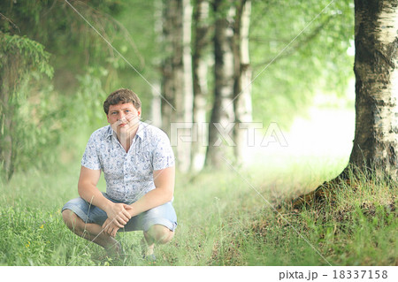 man sitting in a summer forest man sitting in a summer forest 18337158