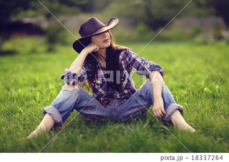 Happy American woman in a cowboy hat field wild flowers Happy American woman in a cowboy hat field wild flowers 18337264