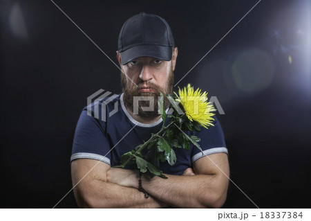 bearded brutal man with a flower 18337384
