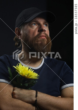 bearded brutal man with a flower 18337385