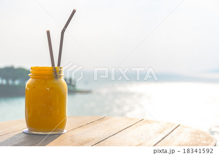 Mango juice with beautiful sea in background 18341592