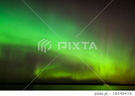 Northern lights over lake in finland 18346419