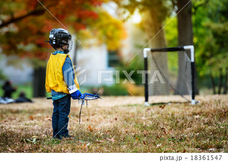 Little kid playing lacrosse with his stick Little kid playing lacrosse with his stick 18361547
