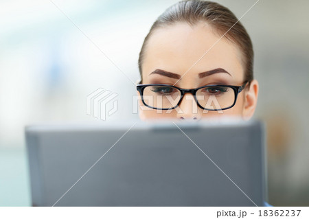 Office worker closely looks into the monitor. Office worker closely looks into the monitor. 18362237