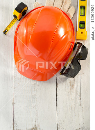 hardhat and safety glasses on wood 18369926