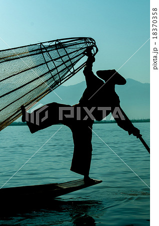 Silhouette of Fisherman at Inle Lake standing on 18370358