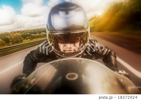 Biker racing on the road Biker racing on the road 18372024