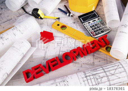 Hard hat with blueprints and rulers 18376361