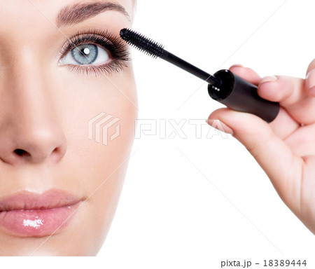 woman applying mascara on eyelashes woman applying mascara on eyelashes 18389444