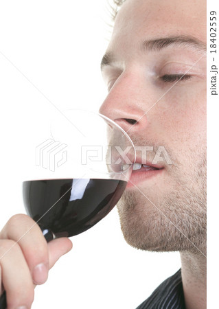 Casual young man holding glass of wine, smiling 18402559