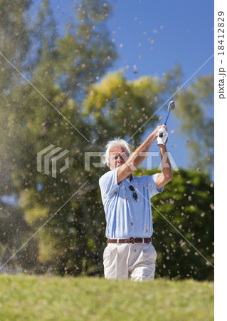 Senior man celebrating playing golf in bunker Senior man celebrating playing golf in bunker 18412829