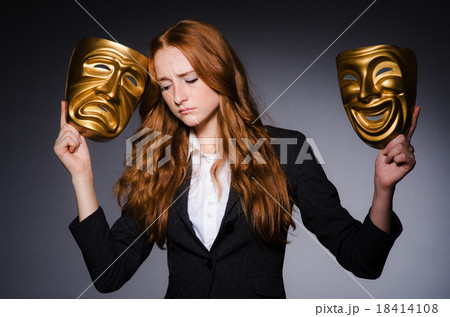 Woman with mask in hypocrisy concept Woman with mask in hypocrisy concept 18414108