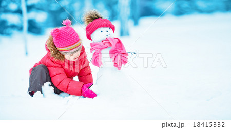 happy child girl with a snowman on a winter walk happy child girl with a snowman on a winter walk 18415332