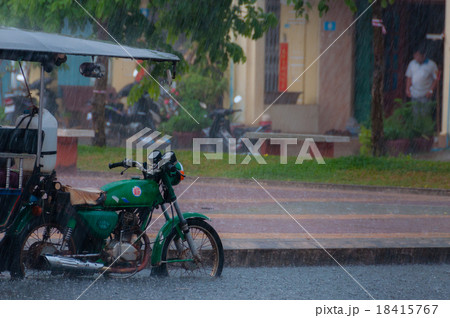 Tuktuk motocycle during rain monsoon in Kampot 18415767