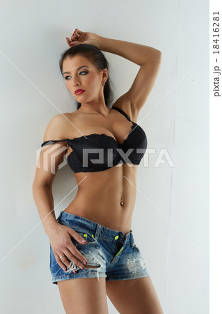 Image of hot babe posing in bra and denim shorts - Stock Photo