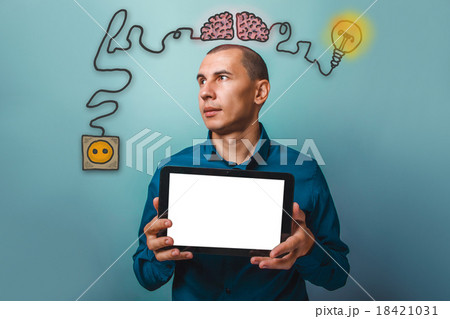 a man looking away and holding a tablet in the 18421031