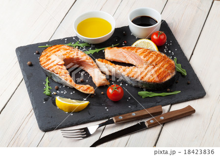 Grilled salmon, salad and condiments Grilled salmon, salad and condiments 18423836