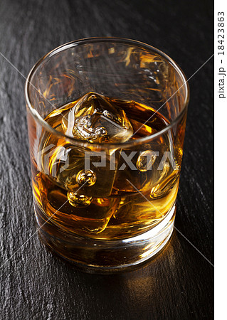 Glass of scotch whiskey with ice 18423863