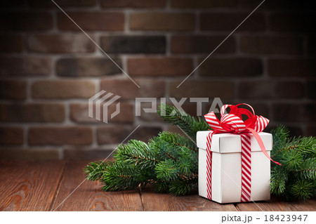 Christmas gift box and tree branch Christmas gift box and tree branch 18423947