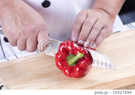 Chef cutting red bell pepper 18427894