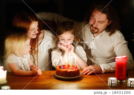 Family celebrating their daughter's birthday Family celebrating their daughter's birthday 18431300