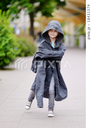 Funny little girl wearing her fathers' coat 18431374