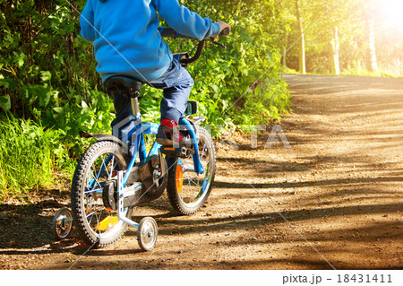 Boy on bike in the forest Boy on bike in the forest 18431411