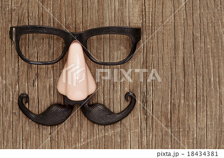 fake mustache, nose and eyeglasses on wooden 18434381
