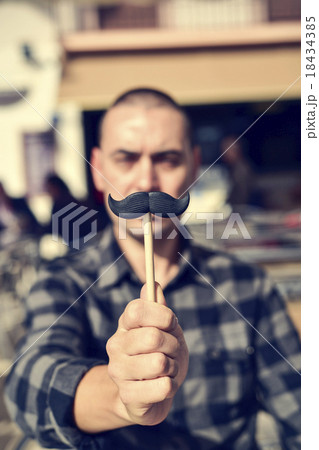 young man with a fake moustache 18434385