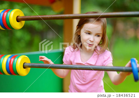 Little girl having fun at a playground Little girl having fun at a playground 18436521