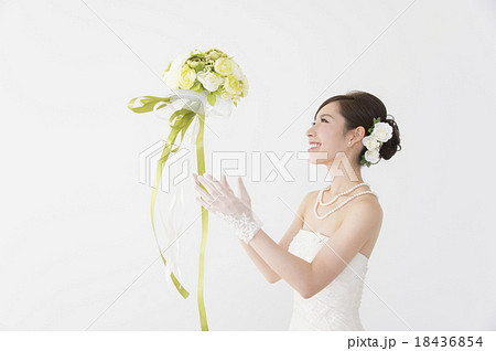 ブーケトスをする花嫁の写真素材