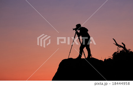 Silhouette of a photographer shooting a sunset Silhouette of a photographer shooting a sunset 18444958
