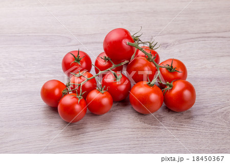 Fresh cherry tomatoes on rustic wooden background Fresh cherry tomatoes on rustic wooden background 18450367