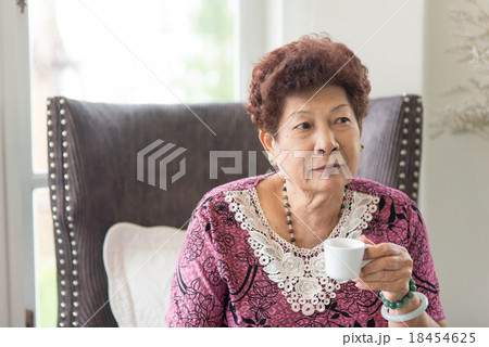 Happy Asian senior woman drinking tea at home. 18454625