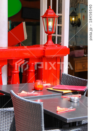 Menu and red candle on black tables of street cafe 18456540