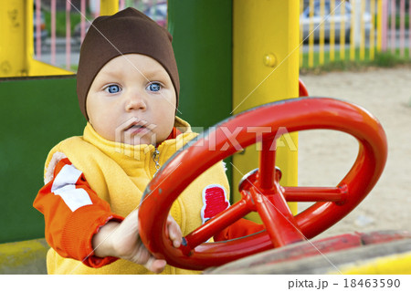 One year small boy at the car wheel 18463590