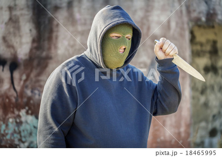Dangerous man with kitchen knife near building wal Dangerous man with kitchen knife near building wal 18465995