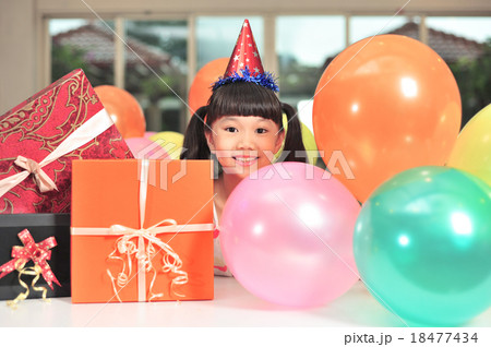Happy Asian girl posing with balloons and presents 18477434