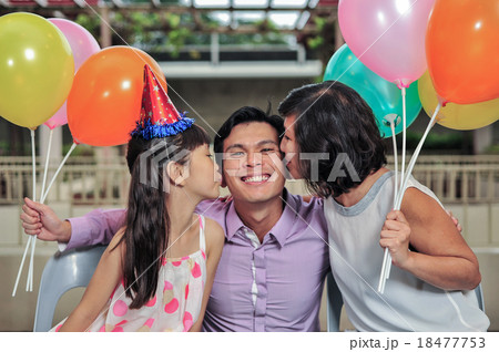 Young Asian mother and daughter kissed father Young Asian mother and daughter kissed father 18477753