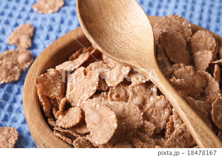 bran flakes in a wooden bowl closeup. horizontal bran flakes in a wooden bowl closeup. horizontal 18478167