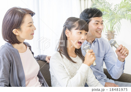 家族でカラオケを熱唱する家族イメージの写真素材