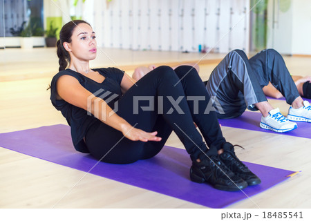 Work out group of people doing sit ups abs 18485541