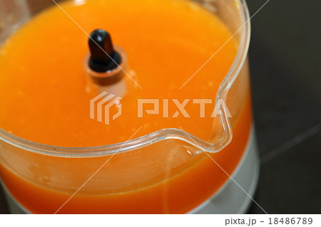 fresh orange juice in juicer machine with hand 18486789
