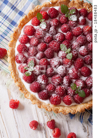 raspberry tart with cream cheese and mint closeup 18488483