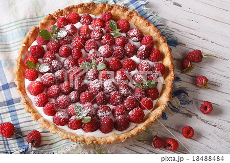 raspberry tart with cream cheese and mint closeup 18488484