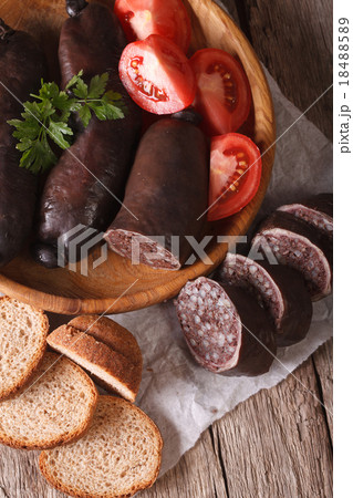 Fresh black pudding on a plate close-up top view Fresh black pudding on a plate close-up top view 18488589