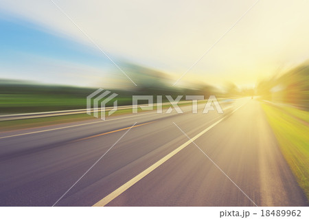 Empty asphalt road in motion blur and sunlight Empty asphalt road in motion blur and sunlight 18489962
