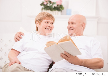 Pleasant adult couple lying on bed  18492010