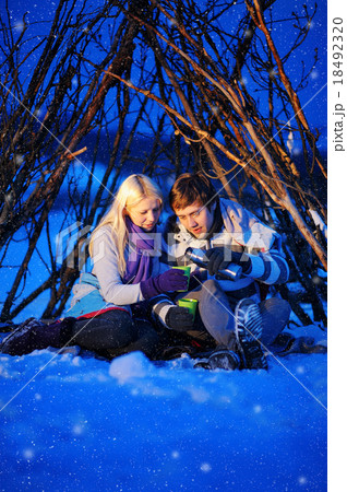 loving couple in a tent drinking tea in winter loving couple in a tent drinking tea in winter 18492320